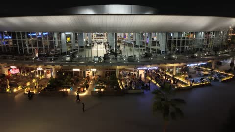 A prominent family shopping and entertainment destination, drone footage of Park Mall on King Faisal Road in the Prince Murooj neighborhood in the city of Tabuk, modern architectural design, places to enjoy quality time with family in the Kingdom of Saudi Arabia.