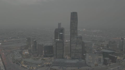 Financial and economic towers and commercial establishments, landmarks and famous places in the Kingdom of Saudi Arabia, the architectural engineering art of buildings and skyscrapers in modern style, aerial photography of urban development and civilizational progress, foggy atmospheres.
