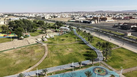 Strolling and enjoying public parks, drone photography of Prince Fahd bin Sultan Park in Tabuk Province, attention to afforestation and planting green plants in parks and recreational areas, a famous tourist spot and landmark, a distinctive natural view in the Kingdom of Saudi Arabia.