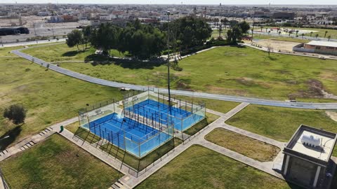 A famous place and tourist attraction, a distinctive natural view in the Kingdom of Saudi Arabia, attention to afforestation and planting green plants in parks and recreational areas, strolling and walking in public gardens, drone photography of Prince Fahd bin Sultan Park in Tabuk Province.