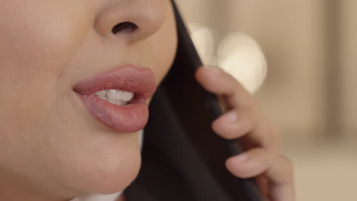 Making a phone call via mobile, a Saudi Arabian Gulf woman in a hijab is talking on her mobile phone, connecting and communicating with friends, ordering a product online.