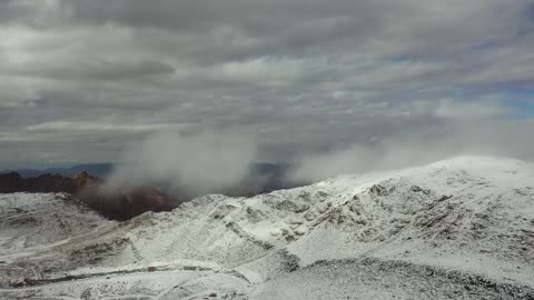Carved mountains and mountain formations in the city of Tabuk, cultural and tourist landmarks in the Kingdom of Saudi Arabia, snowfall, low pressure system, winter atmosphere, the Shada Mountains in the Trojena area covered in snow, aerial drone photography of rock formations in the village of Jeddah Neom in the west of the Kingdom of Saudi Arabia.