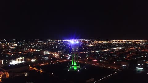 The tower has been prepared to be a complete tourist destination, landmarks of the city of Tabuk, the Tabuk Tower in Saudi Arabia, one of the most prominent architectural and tourist landmarks in the city of Tabuk in the Kingdom of Saudi Arabia, aerial drone photography of the Tabuk Tower at night, a tourist attraction in Saudi Arabia, which was used in the past to store and cool water.