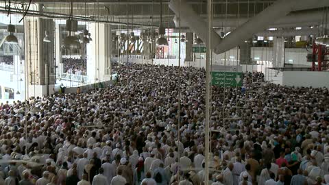 Muslim pilgrims are circling around the Holy Kaaba in Mecca, a drone shot from inside the Sacred Mosque in the Kingdom of Saudi Arabia, domes and minarets of the Grand Mosque, performing the rituals of Hajj and Umrah, worship and drawing closer to God, sacred Islamic religious landmarks.
