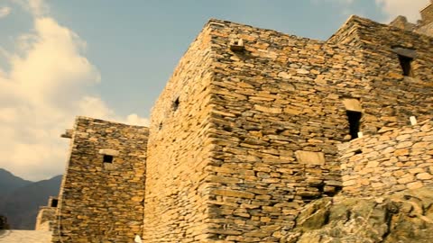 Attracting and drawing tourists from around the world, architectural engineering art in the old style, the heritage village of Rijal Almaa in the Asir region during the day, ancient historical buildings and houses, famous landmarks and tourist places in the Kingdom of Saudi Arabia.