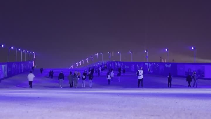 Night atmosphere in the outdoor activities area, Soundstorm Middle Beast Festival in the Binban area of Riyadh, December 13, 2025, in the Kingdom of Saudi Arabia, strong blue lighting extending over the open path, visitors wandering in an enjoyable atmosphere filled with fun and entertainment, a delightful family and youth experience as part of the Riyadh Season events.