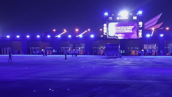 Night atmosphere in the outdoor activities area, Soundstorm Middle Beast Festival in the Binban area of Riyadh, December 13, 2025, in the Kingdom of Saudi Arabia, strong blue lighting extending over the open path, visitors wandering in an enjoyable atmosphere filled with fun and entertainment, a delightful family and youth experience as part of the Riyadh Season events.