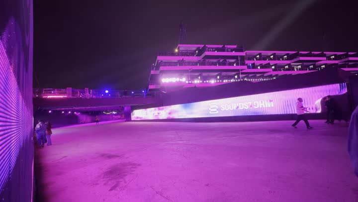 The Soundstorm Middle Beast Festival in the Banban area of Riyadh, December 13, 2025, in the Kingdom of Saudi Arabia, features a nighttime atmosphere in the outdoor activities area, with strong purple lighting extending over the open path. Visitors stroll through a fun and entertaining environment, enjoying a delightful family and youth experience as part of the Riyadh Season events.