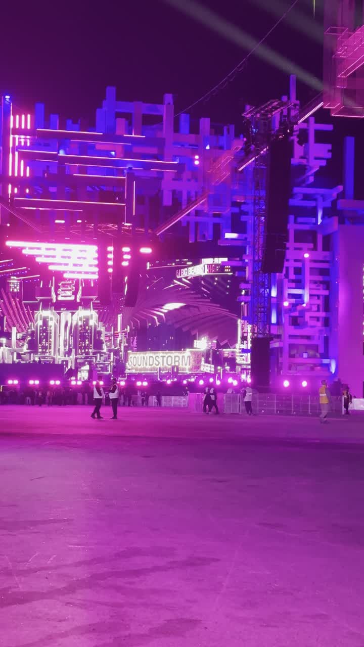 Night atmosphere in the outdoor activities area, Soundstorm Middle Beast Festival in the Binban area of Riyadh, December 13, 2025, in the Kingdom of Saudi Arabia, strong purple lighting extending over the open path, visitors wandering in an atmosphere filled with fun and entertainment, a family and youth experience as part of the Riyadh Season events.