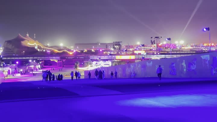 Night atmosphere in the outdoor activities area of the Soundstorm Middle Beast Festival in the Banban area of Riyadh, December 13, 2025, in the Kingdom of Saudi Arabia. Strong blue lighting extends over the open path, with visitors strolling through enjoyable and entertaining surroundings, a family and youth experience as part of the Riyadh Season events.