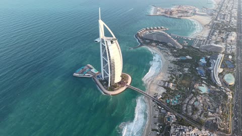The growth and urban development on the Arabian Gulf coast, the architectural engineering art of towers and skyscrapers, attracting and drawing tourists from around the world, the Burj Al Arab hotel in Dubai, the tourist facade in the United Arab Emirates.