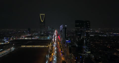 The development and urban growth in the Kingdom of Saudi Arabia, drone photography of the architectural art of the city of Riyadh at night, the towers and skyscrapers in the capital, the Kingdom Tower building in Riyadh, famous tourist landmarks.