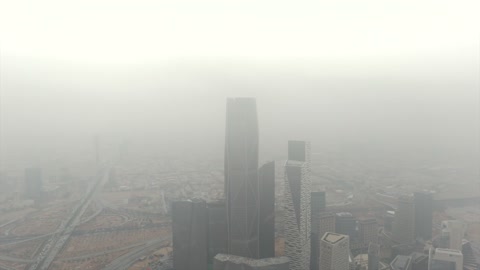 Famous landmarks of Riyadh, aerial drone photography of the King Abdullah Financial Center (KAFD), the illuminated financial and economic towers in the city of Riyadh, the architectural engineering art of the towers and skyscrapers in the Kingdom of Saudi Arabia, famous places and landmarks, a view of the sky filled with clouds.