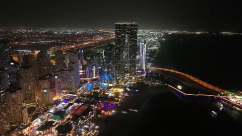 Aerial drone photography of the towers and skyscrapers of Marina in Dubai, architectural engineering art, tourism in the UAE, resorts and hotels in the United Arab Emirates at night.