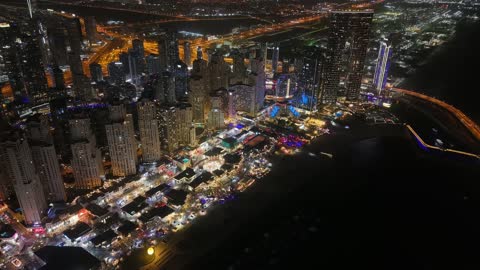 Aerial drone photography of the towers and skyscrapers of Marina in Dubai, architectural engineering art, tourism in the UAE, resorts and hotels in the United Arab Emirates at night.