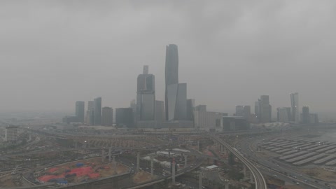 King Abdullah Financial District (KAFD), the famous landmarks of Riyadh, the illuminated financial and economic towers in the city of Riyadh, the architectural engineering art of the towers and skyscrapers in the Kingdom of Saudi Arabia, the famous places and landmarks, the view of the sky filled with clouds.