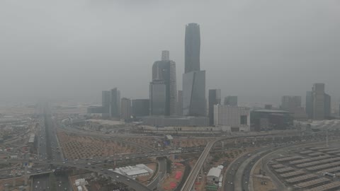 Famous landmarks of Riyadh, King Abdullah Financial Center (KAFD), the illuminated financial and economic towers in the city of Riyadh, the architectural engineering art of the towers and skyscrapers in the Kingdom of Saudi Arabia, famous places and landmarks, the view of the sky filled with clouds.