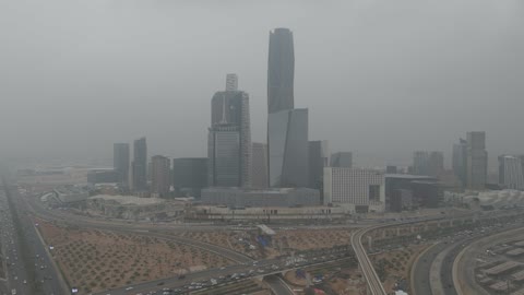 Famous landmarks of Riyadh, King Abdullah Financial Center (KAFD), the illuminated financial and economic towers in the city of Riyadh, the architectural engineering art of the towers and skyscrapers in the Kingdom of Saudi Arabia, famous places and landmarks, the view of the sky filled with clouds.