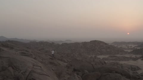 Hiking in Saudi Arabia, drone footage of the mountains and rocks in the city of Jeddah, Saudi Arabia at sunset, landscapes, a group of young people practicing hiking, strolling in Jeddah, tourism in Saudi Arabia.