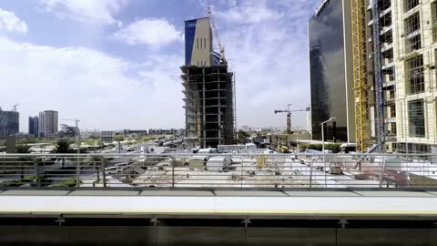 RIYADH city, Riyadh, SAUDI ARABIA - Nov 30 2025: Wide panning shot of Riyadh city skyline featuring corporate headquarters, modern office buildings, and highway traffic infrastructure.