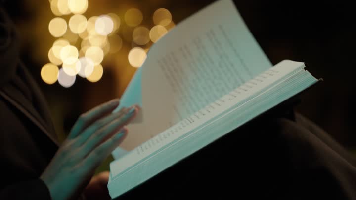 تصوير مقرب ليد امراة عربيه خليجيه سعودية تقوم بقراءة كتاب في الهواء الطلق , الجلوس على الأرض في إحدى الحدائق العامه, تمضية أوقات الفراغ بالتعلم والتثقف الذاتي