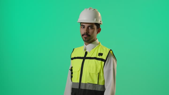مهندس عربي خليجي سعودي يرتدي خوذة الامان و الصديري العاكس للضوء , الحفاظ على تعليمات السلامة في مواقع البناء , تعابير الثبات و الثقة
