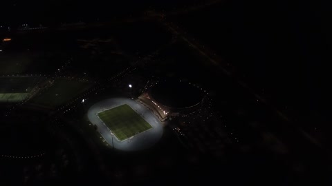 Drone footage of the Jewel Stadium in King Abdullah Sports City in Jeddah, a global sports destination for hosting the World Cup, focusing on sports and entertaining recreational activities, modern architectural engineering art.