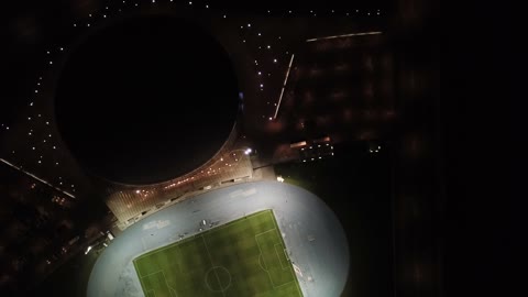 Drone footage of the Jewel Stadium in King Abdullah Sports City in Jeddah, a global sports destination for hosting the World Cup, focusing on sports and entertaining recreational activities, modern architectural engineering art.