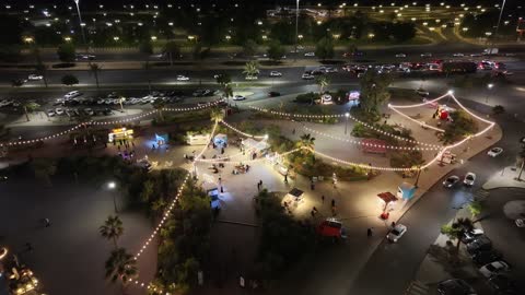 A place to spend quality time with family in Saudi Arabia, modern architectural engineering art, a family shopping and entertainment destination, drone footage of the Park Mall at night on King Faisal Road in the Prince Murooj neighborhood in the city of Tabuk.