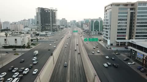 The growth and urban development of facilities, drone footage of car traffic on the roads of Jeddah city in the Kingdom of Saudi Arabia, the concept of strolling in the streets of Jeddah.