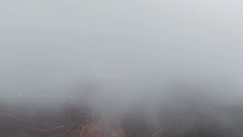 Hail (small snowflakes) fell over the volcanic harrahs area in Tabuk, with a foggy winter atmosphere over the mountain in the sky of the city of Hura Tabuk in the Kingdom of Saudi Arabia.
