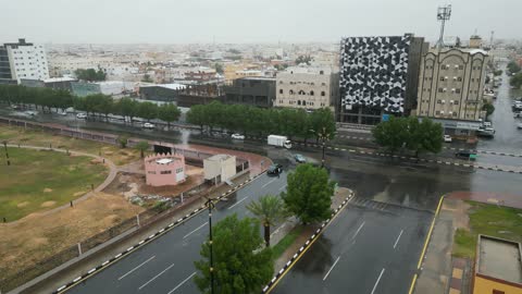 Aerial shot of the city of Tabuk with rain, tourist places and areas in the Kingdom of Saudi Arabia, drone footage of the flood in the city of Tabuk, gathering of rainwater in the area, famous tourist landmarks.
