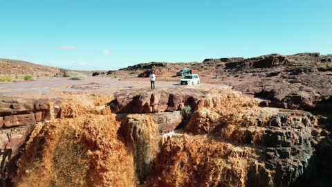 The flow of the stream after heavy rainfall, the Shak Waterfall in the west of Tabuk city in the Kingdom of Saudi Arabia, the mountain, desert, and coast, a landmark and tourist area, nature in Tabuk.