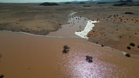 The flooding of the valleys in the waters of the torrents in the Tabuk mountains, the beauty of the city of Tabuk in Saudi Arabia, the flow of torrents after heavy rainfall, the waterfalls of Al-Shaq in the west of the city of Tabuk in the Kingdom of Saudi Arabia, the mountains, deserts, and coasts, nature in Tabuk.
