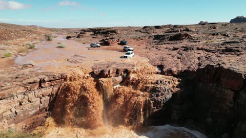 The flooding of the valleys in the waters of the torrents in the Tabuk mountains, the beauty of the city of Tabuk in Saudi Arabia, the flow of torrents after heavy rainfall, the waterfalls of Al-Shaq in the west of the city of Tabuk in the Kingdom of Saudi Arabia, the mountains, deserts, and coasts, nature in Tabuk.