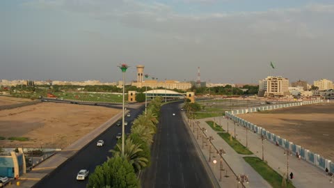 Traffic of cars in the streets of Tabuk city, a public amusement park in the Kingdom of Saudi Arabia, a place to have a good time, the architectural engineering art of buildings, the attention to planting and green spaces in cities.