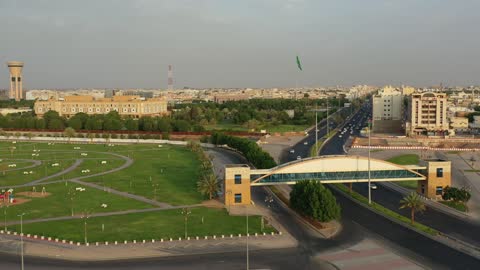 Traffic of cars in the streets of Tabuk city, a public amusement park in the Kingdom of Saudi Arabia, a place to have a good time, the architectural engineering art of buildings, the attention to planting and green spaces in cities.