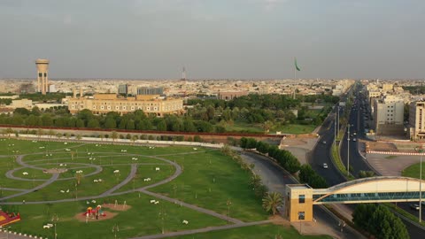 Traffic of cars in the streets of Tabuk city, a public amusement park in the Kingdom of Saudi Arabia, a place to have a good time, the architectural engineering art of buildings, the attention to planting and green spaces in cities.