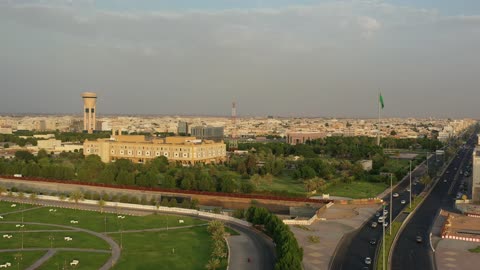 Traffic of cars in the streets of Tabuk city, a public amusement park in the Kingdom of Saudi Arabia, a place to have a good time, the architectural engineering art of buildings, the attention to planting and green spaces in cities.