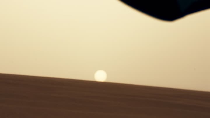 The flag of the United Arab Emirates flutters amidst the desert areas, the soft golden sands, the concept of patriotism and belonging to it, the formations and structures of sand in the desert, UAE National Day December 2.