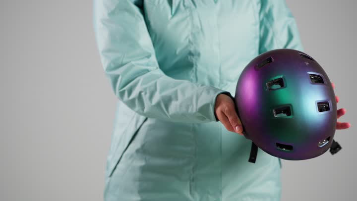 الاستعداد لبداية النشاط الممتع , امرأة عربية خليجية سعودية ترتدي ملابس التزلج على الجليد الثقيلة لتشعر بالدفء ,وضع خوذة الرأس للحماية اثناء السقوط , امرأة اماراتية ,