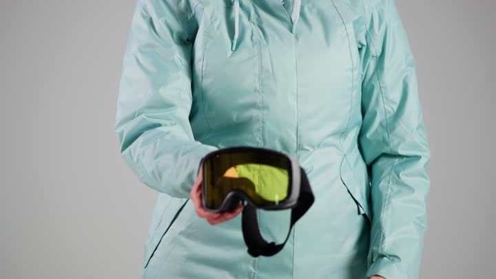 ارتداء نظارة الجليد الصفراء للحفاظ على سلامة  العين من تطاير قطع الثلج الصغيرة , امرأة عربية خليجية سعودية ترتدي ملابس التزلج على الجليد الثقيلة , امرأة اماراتية