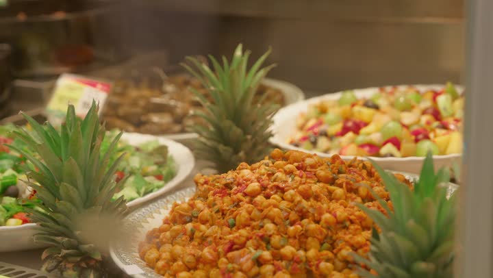 تصوير مقرب لأطباق متنوعة من السلطات والمقبلات داخل قسم الأطعمة الجاهزة في السوبر ماركت ، أطباق سلطة الفواكه والخضروات وأطعمة عربية شعبية مع الأناناس، مفهوم التسوق وشراء الوجبات الجاهزة، طعام صحي وطازج، مأكولات متنوعة داخل ثلاجة العرض