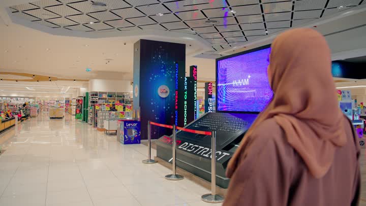 الاستمتاع بالتسوق والترفيه داخل المراكز التجارية، تصوير مقرب لامرأة عربية خليجيه اماراتية محجبة ترتدي العباءة تسير داخل داخل المولات التجارية الحديثة