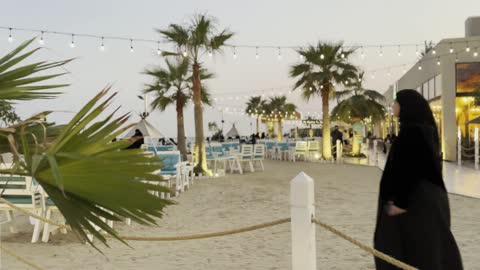 A place adorned with a string of lights, the tourist waterfront in the Kingdom of Saudi Arabia in the city of Jubail Industrial in the Eastern Province, Jubail Corniche, a café and a place with innovative lights, famous tourist attractions.