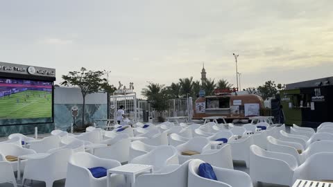 A large screen and white seats prepared for the audience, "Takiya Bahr" waterfront, Al Jubail Corniche, famous tourist landmarks, the tourist waterfront in the Kingdom of Saudi Arabia in the city of Jubail Industrial, a collection of restaurants and cafes overlooking the sea.