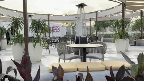Pyramid-shaped patio heaters for warmth in cold weather, "Bahri Takiya" waterfront, Al Jubail Corniche, famous tourist attractions, the tourist waterfront in the Kingdom of Saudi Arabia in the city of Jubail Industrial, a collection of restaurants and cafes overlooking the sea.