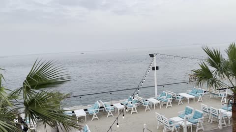 Small palm trees, wooden and plastic furniture, a collection of restaurants and cafes overlooking the sea, the tourist waterfront in the Kingdom of Saudi Arabia in the city of Jubail Industrial on December 28, 2025, Jubail Corniche, famous tourist attractions.