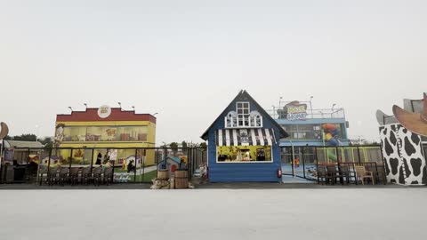 Additional wooden structures, small buildings, and retail outlets, Winter Wonderland in the Al Shatea neighborhood in Jeddah, Saudi Arabia on December 19, 2025, entertainment games and interactive experiences, live shows and enjoyable lights, festive snowy atmosphere.