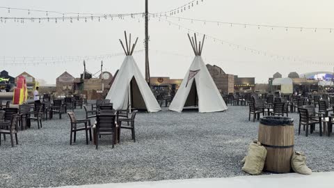 Wooden and plastic chairs and tables throughout the area, Winter Wonderland in the Al Shati neighborhood in Jeddah, Saudi Arabia on December 19, 2025, entertainment games and interactive experiences, live shows and fun lights, festive snowy atmosphere.